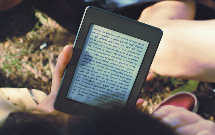 a hand holding an e-ink reader